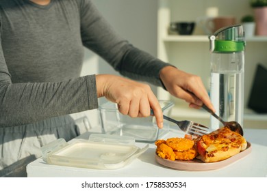 Woman Picking Up Slice Of Pizza From Plate.