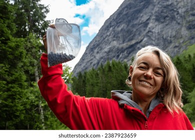 Woman picking wild blueberries during summer in Scandinavia  - Powered by Shutterstock