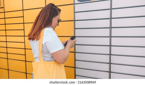 Woman picks up mail from automated self-service post terminal machine. Parcel shipping service or delivery packaging concept