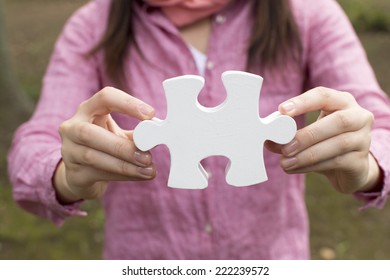 Woman With A Piece Of Jigsaw Puzzle