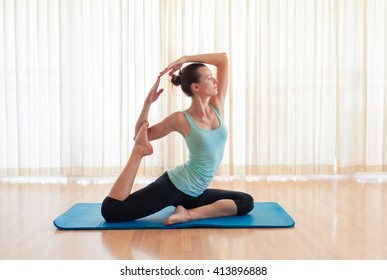 Woman In Pigeon Yoga Pose