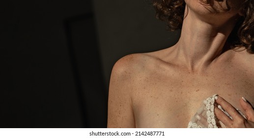Woman with pigmentation and freckles on the body close-up on a dark background - Shutterstock ID 2142487771