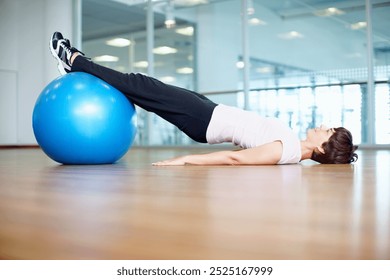 Woman, pilates ball and plank exercise at gym, balance and abdominal workout for strong core. Female person, equipment and yoga fitness or challenge in studio, health centre and training development - Powered by Shutterstock