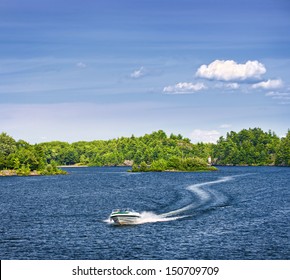 Woman piloting motorboat on lake in Georgian Bay, Ontario, Canada