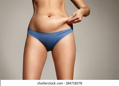 woman pinched her fat on body