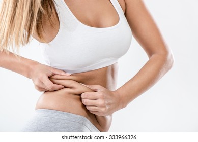 Woman Pinching Waist And Checking Her Body Fat. Close-up.