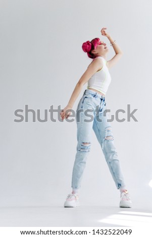woman with pink hair in jeans stood on socks