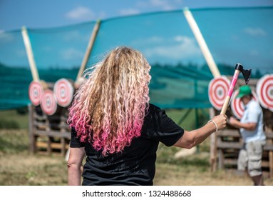 A Woman With The Pink Hair Is Ready For Throwing Axe On Competition.