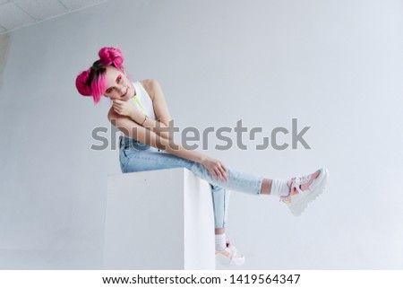 woman with pink hair sits outdoors place free cube fashion
