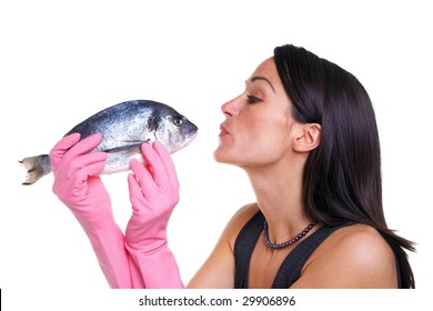 Woman in pink rubber gloves about to kiss a fish, isolated on white background.