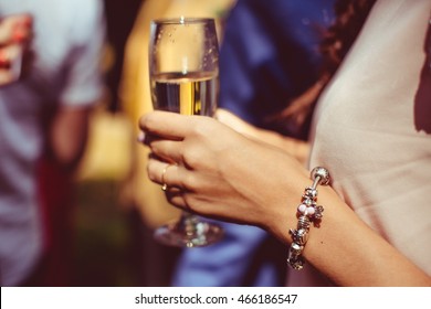 Woman With Pink And Silver Bracelet Holds A Champagne Flute