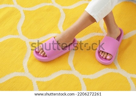 Woman in pink slippers indoors, closeup view