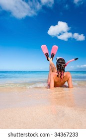 Woman In Pink Snorkel Gear On Sandy Beach