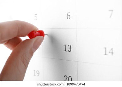 Woman Pinning Friday 13th On Calendar, Closeup. Bad Luck Superstition