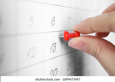 Woman Pinning Friday 13th On Calendar, Closeup. Bad Luck Superstition