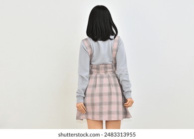 Woman in plaid skirt with shoulder straps - Powered by Shutterstock