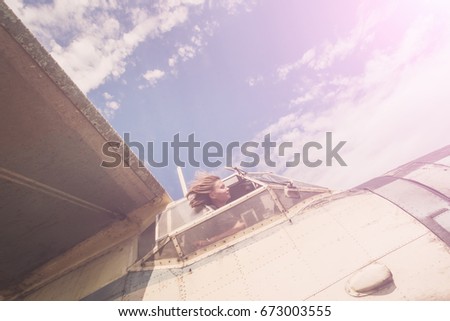 Similar – Woman with sunglasses raising her arms over nature background