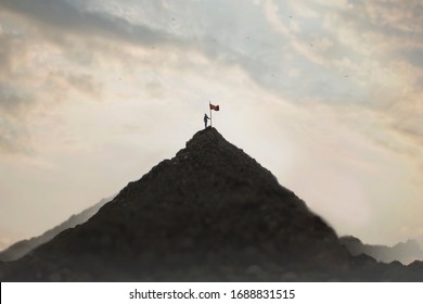 Woman Plants His Flag On The Mountain Peak As A Sign Of Success