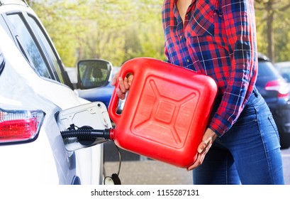 Woman with plastic canister filling car tank - Powered by Shutterstock