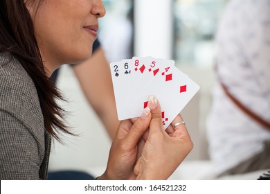 woman play card with friend