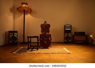 Woman Playing Acoustic Guitar In A Retro Vintage Room.