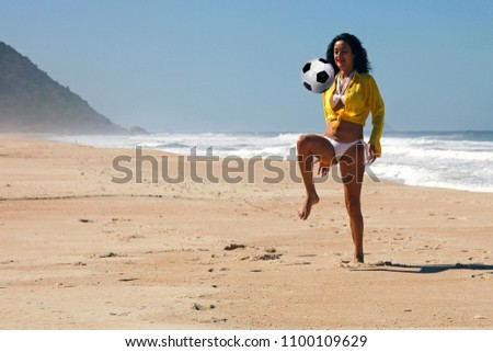 Woman playing ball on the beach