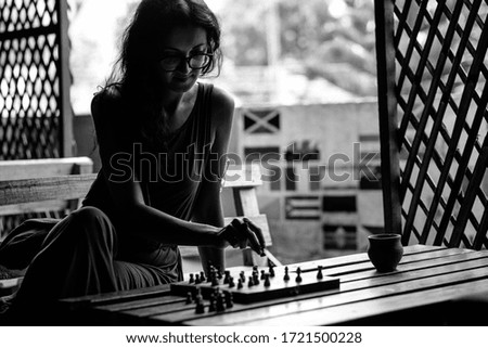 Similar – lifestyle shot of smart kid girl playing checkers at home