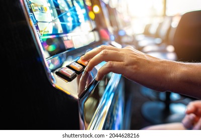 Woman Playing Classic Slot Machine Inside Las Vegas Casino. One Handed Bandit Game Play. Gambling Industry Theme. - Shutterstock ID 2044628216