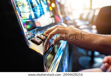 Woman Playing Classic Slot Machine Inside Las Vegas Casino. One Handed Bandit Game Play. Gambling Industry Theme.