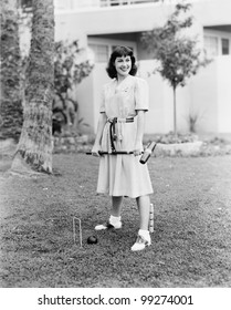 Woman Playing Croquet In The Yard