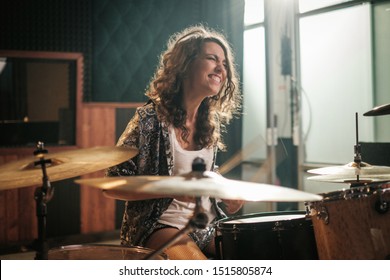 Woman Playing Drums During Music Band Rehearsal