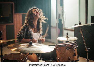 Woman Playing Drums During Music Band Rehearsal