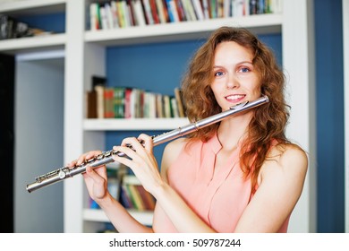 Woman Playing Flute In Library