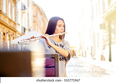 Woman Playing Flute In Town