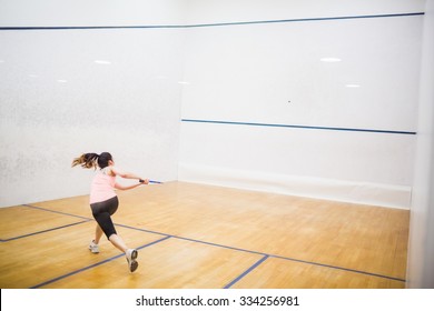 Woman playing a game of squash in the squash court