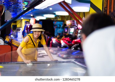 Woman Playing Games At Arcade Entertainment Center