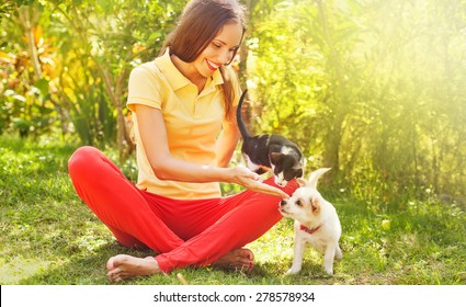 woman playing with her can and dog outdoors - Powered by Shutterstock