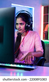 Woman Playing Live Video Game On Computer By Talking To Players On Headphones At Home - Concept Of Live Streamer, Vlogger And Tournament.