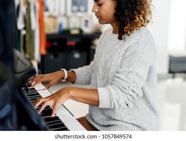 Woman Playing On A Piano