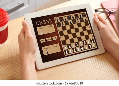 Woman Playing Online Chess On Tablet Indoors, Closeup