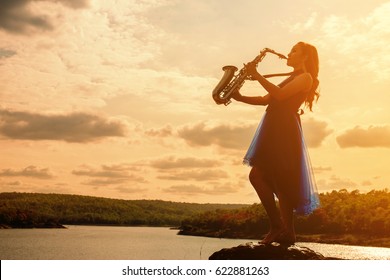 Woman Playing Saxophone Sax At Sunset