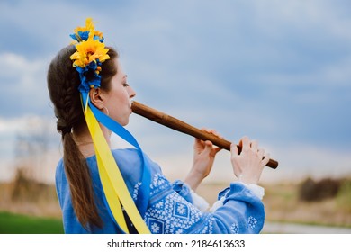 Woman Playing Woodwind Wooden Flute - Ukrainian Sopilka Outdoors. Folk Music, Culture Concept. Musical Instrument. Lady In Traditional Embroidered Shirt - Blue Vyshyvanka.