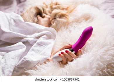 Woman pleasuring herself with vibrator