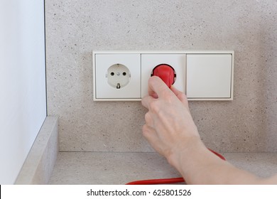 Woman Plugged In An Electric Device In A Triple Power Socket