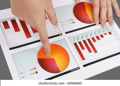 A woman pointing at a colorful chart graph