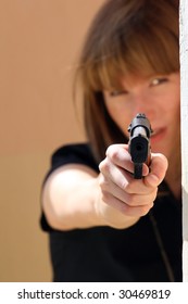 Woman Pointing Gun Into The Camera