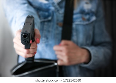 Woman Pointing A Gun At The Target. Conceal Carry Weapon For Protection Themselves Concept. Selective Focus To Gun.