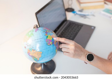 Woman Pointing Out A Country To Travel On The Globe. Travel Concept