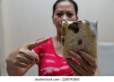 Woman Pointing To Rotten Food. Moldy Bread, Unhealthy Food