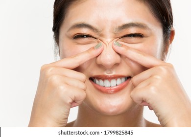 A Woman Is Pointing At The Wrinkles On Her Nose.